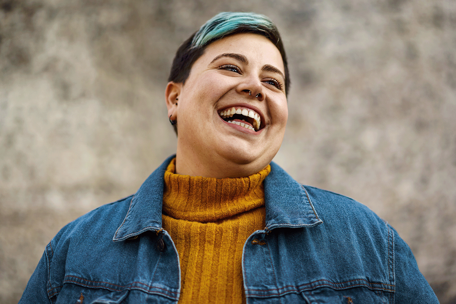 A nonbinary person laughing